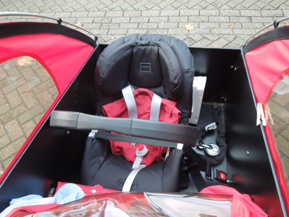 Photo of Christiania cargo bike with front facing baby child car seat