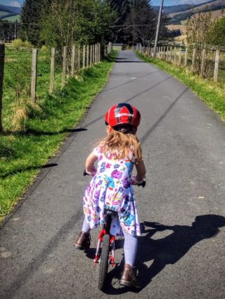 Girl on a bike - learning to ride in a dress