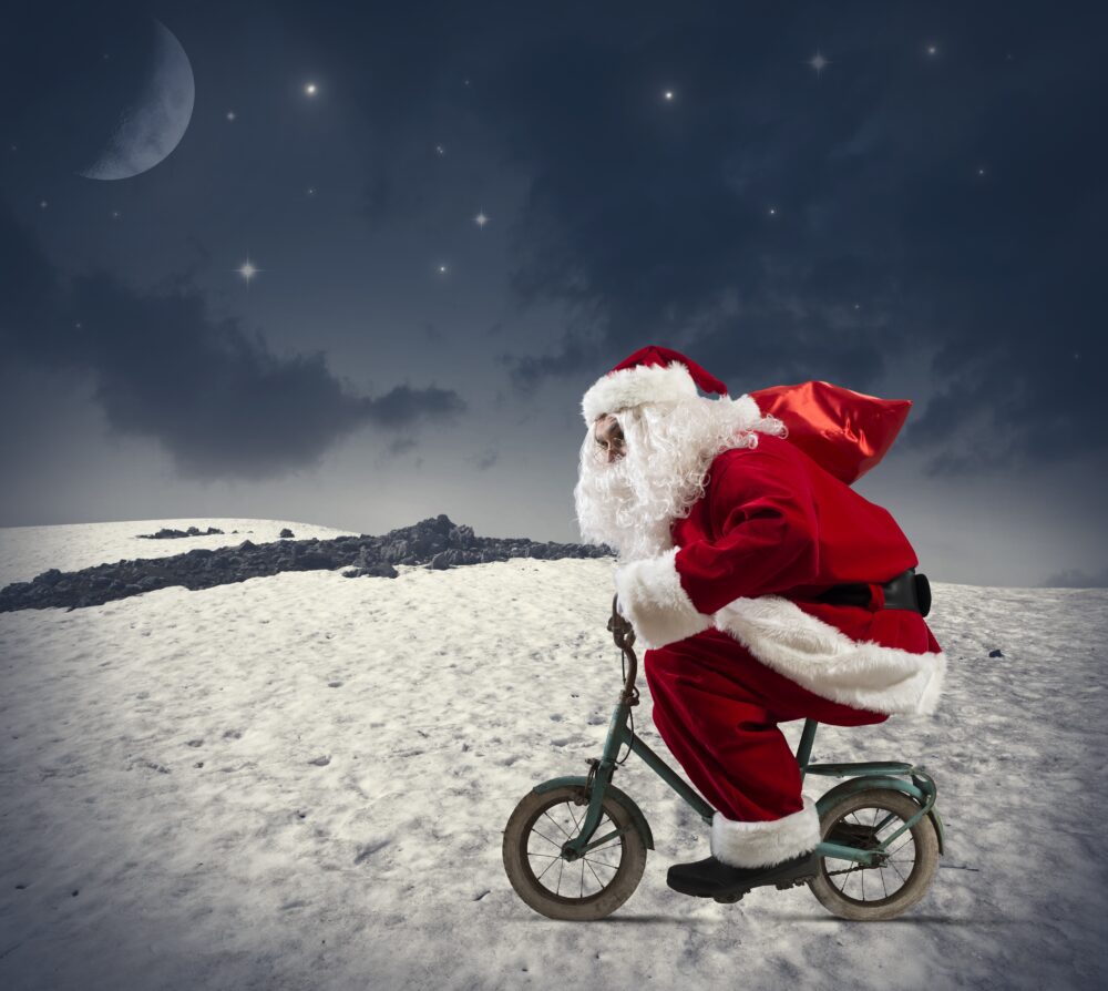 Kids Bike Search - photo of Father Christmas on a small childs bike cycling across the snow