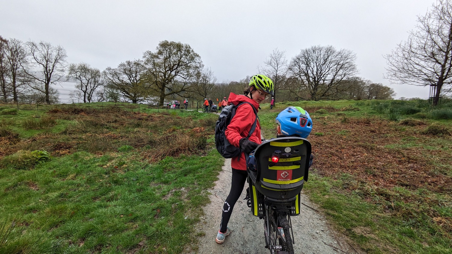 little boy in a hamax rear seat on a bike ride on a rainy day