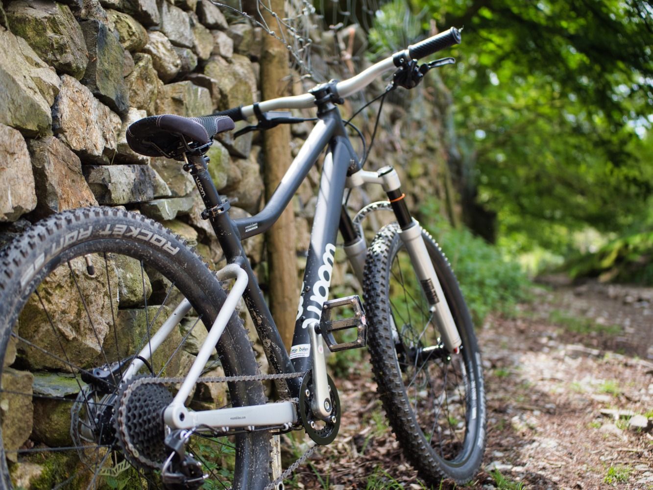 woom OFF AIR 5 review: the woom OFF AIR 5 mountain bike seen from behind, leaning against a wall
