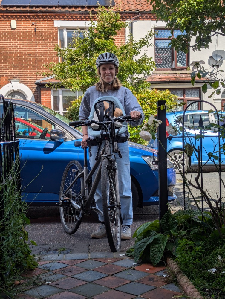 Thule Yepp 2 mini review:A woman with potatoes in a thule yepp 2 mini seat, practicing before riding with her child