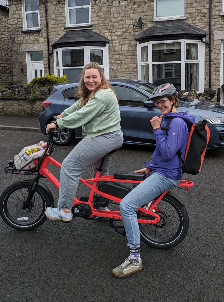 two women riding on the Estarli ecargo longtail bike