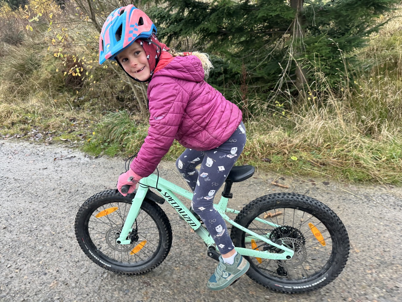 Specialized Riprock 20 review- a photo of a litle girl in a pink jacket riding the blue bike