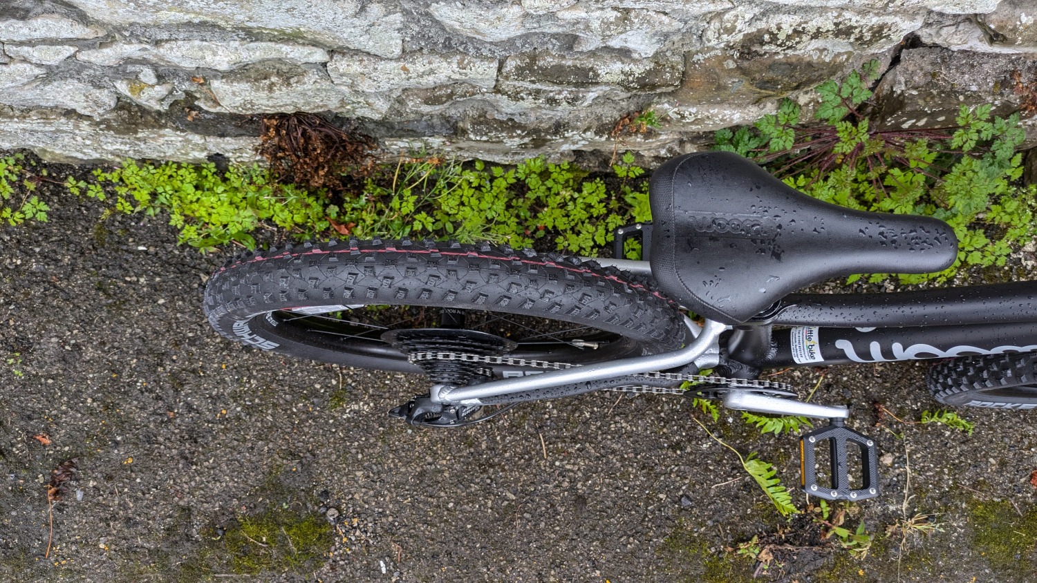 A black and silver woom OFF 4 leant against a stone wall