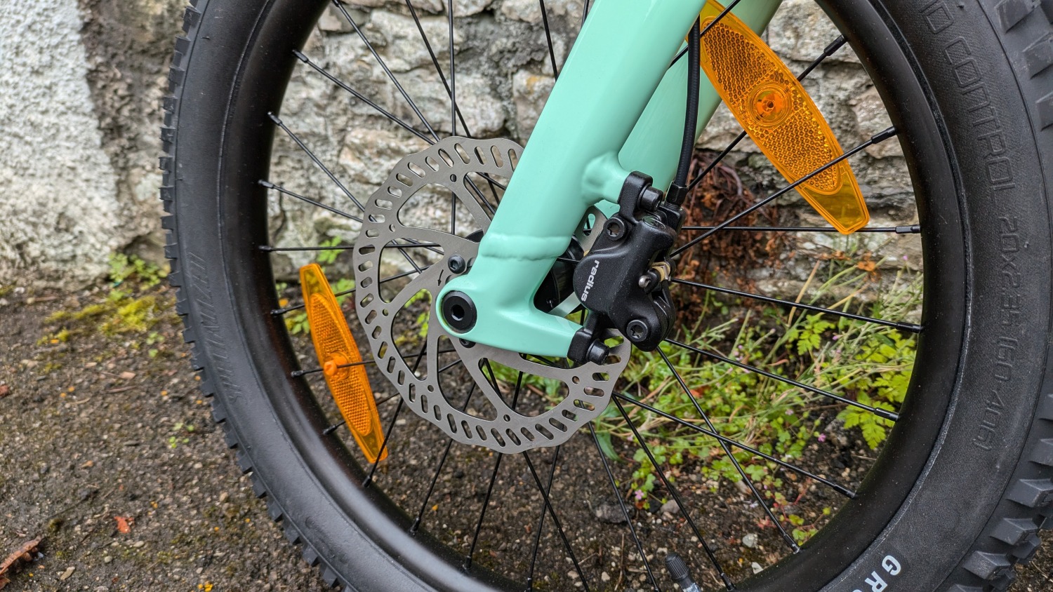 A close up of the brake rotor on the blue specialized riprock