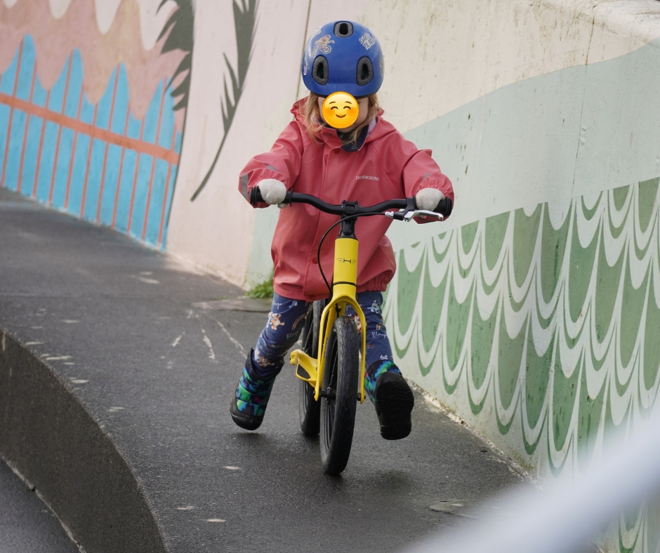 Yellow Hornit AIRO 14 being ridden and reviewed by a girl in a pink jacket 