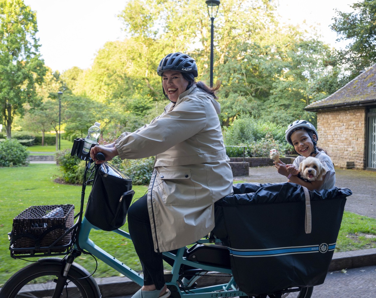 Lisa with her child on the back of a longtail cargo bike by estarli