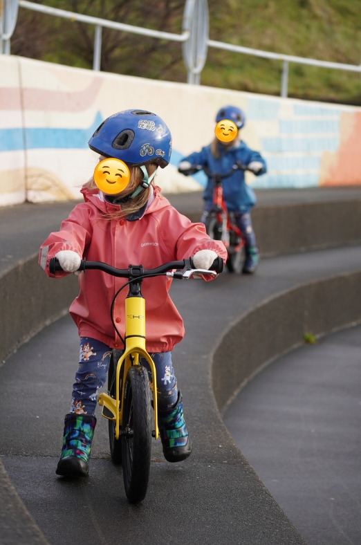 Yellow Hornit AIRO 14 being ridden by a girl in a pink jacket on a large step